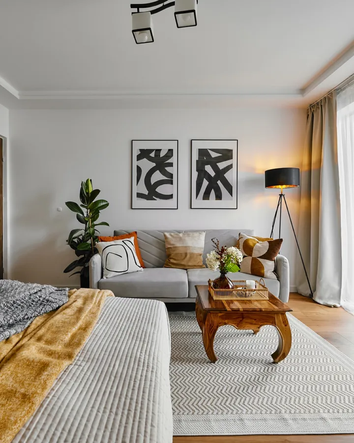 Bedroom with the living area behind it and wooden furniture