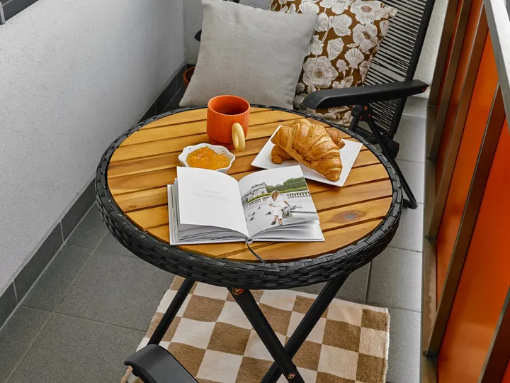 Balcony with a small table and a lounger