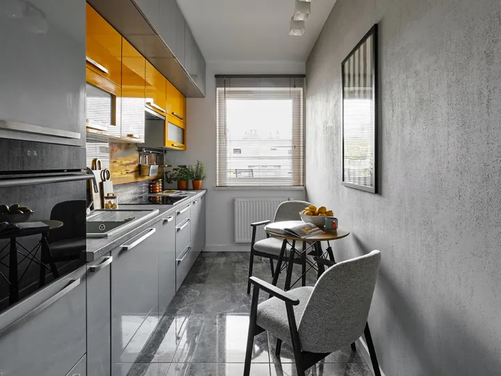 Galley kitchen with a window at the end