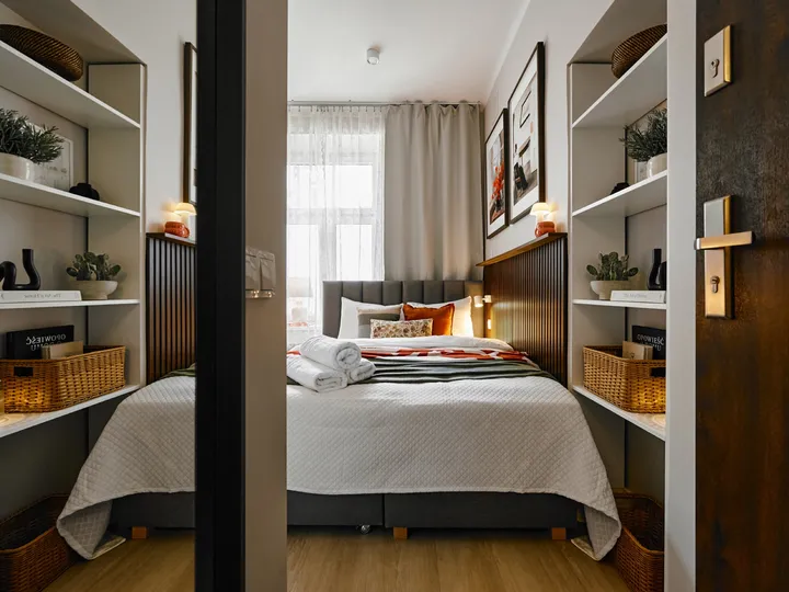 View from the door: shelves and the bed under the window