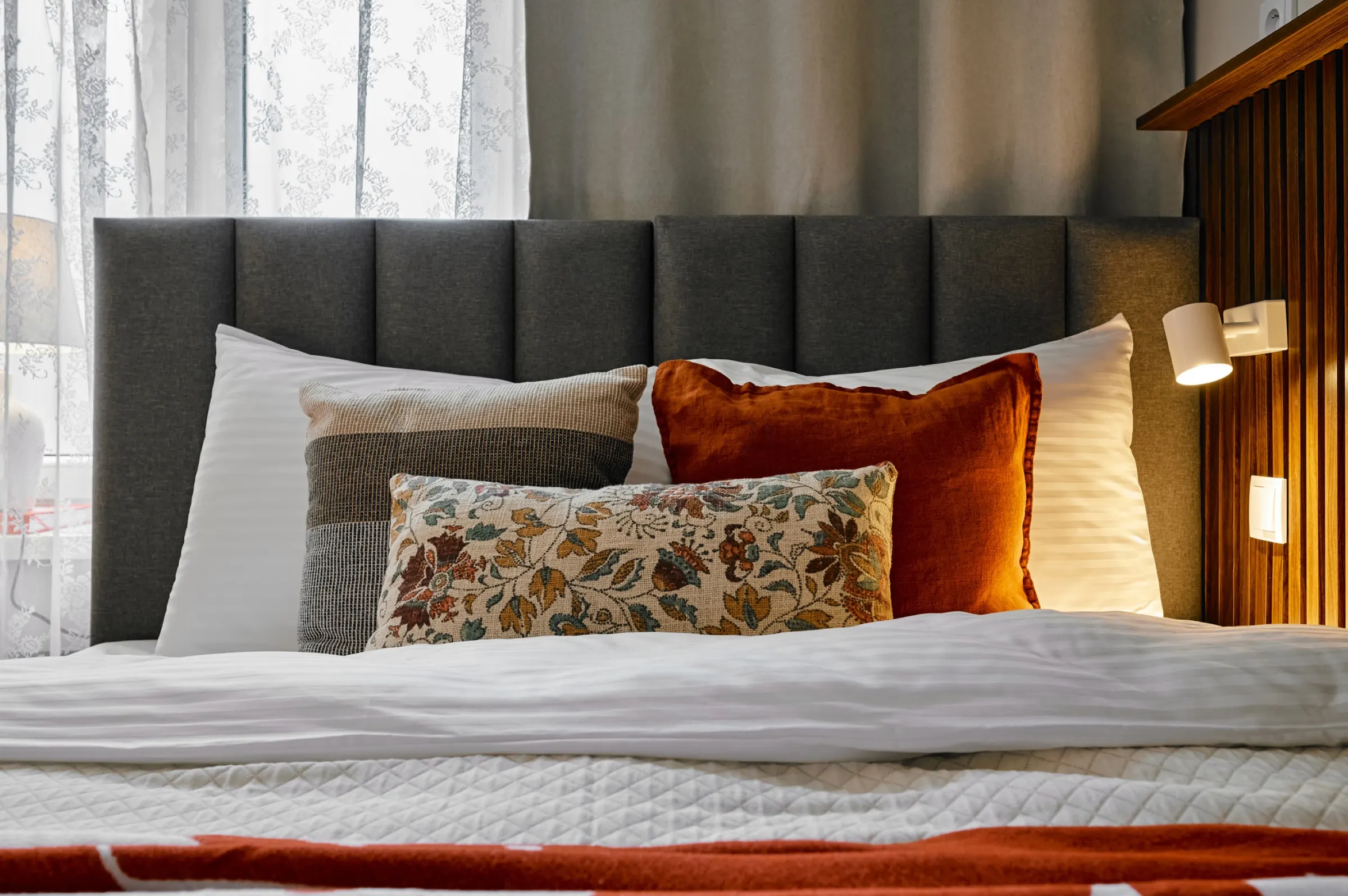 Bed with terracotta cushions