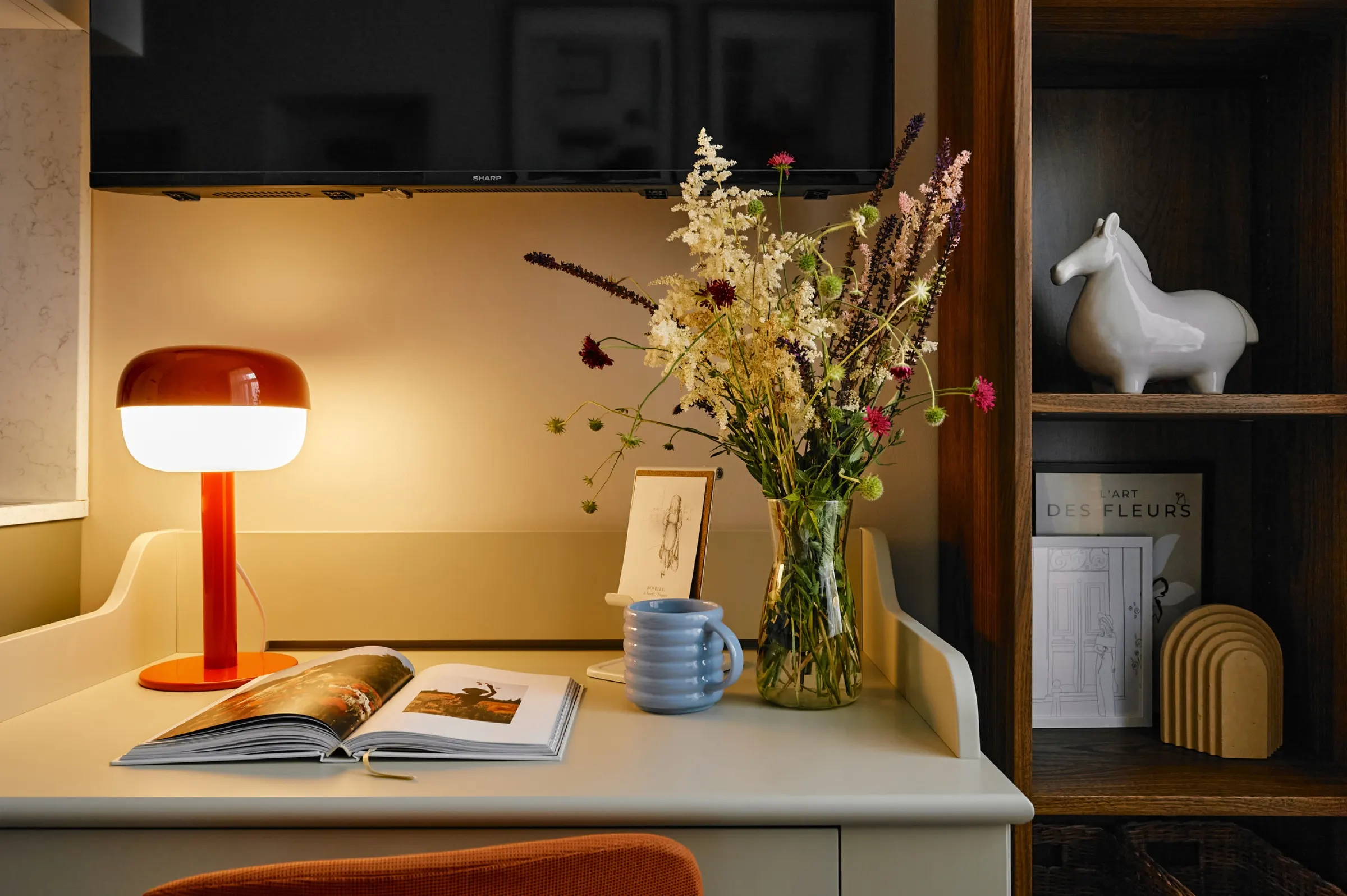 Desk with a red lamp and shelving
