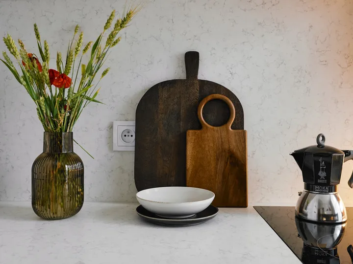 Worktop with a board, moka pot and vase
