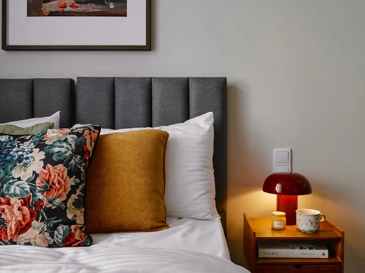 Floral cushions and a bedside lamp