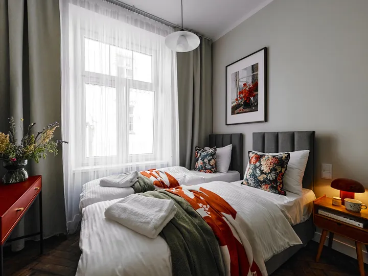 Bed by the tall tenement window