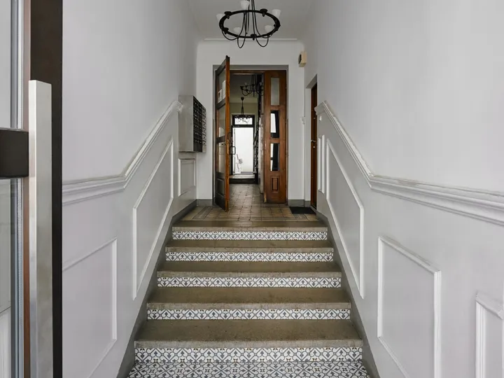 Tenement staircase with patterned floor tiles