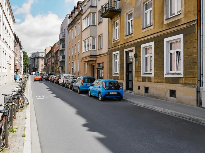 Konarskiego Street lined with tenement houses in the sun